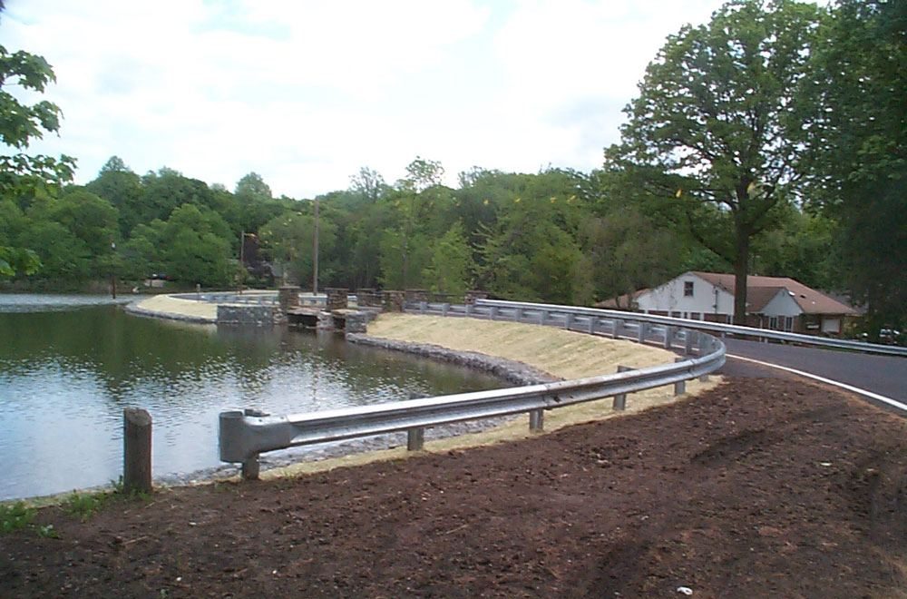 Dam and spillway at the edge of a lake