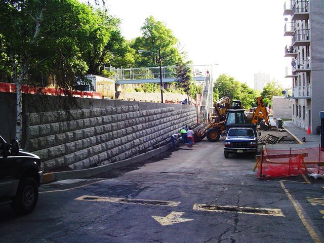 Finished soldier pile and lagging retaining wall beside a street